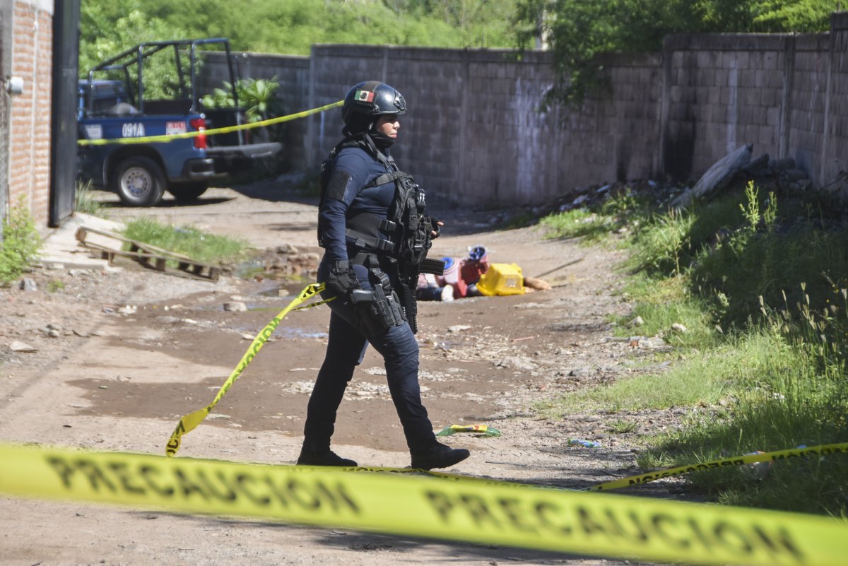 Mexican police officer patrols alley