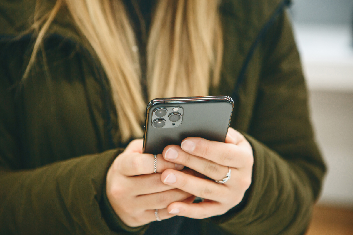 Blonde Girl Holds Phone With Triple Camera