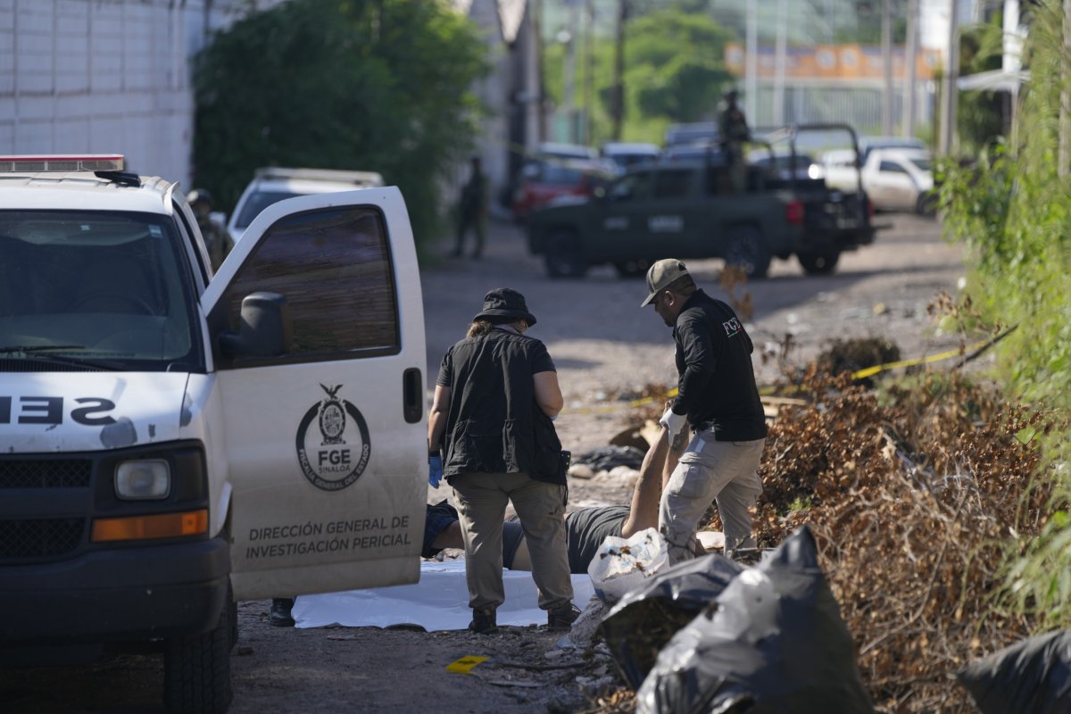 Forensic investigators remove a body in Mexico