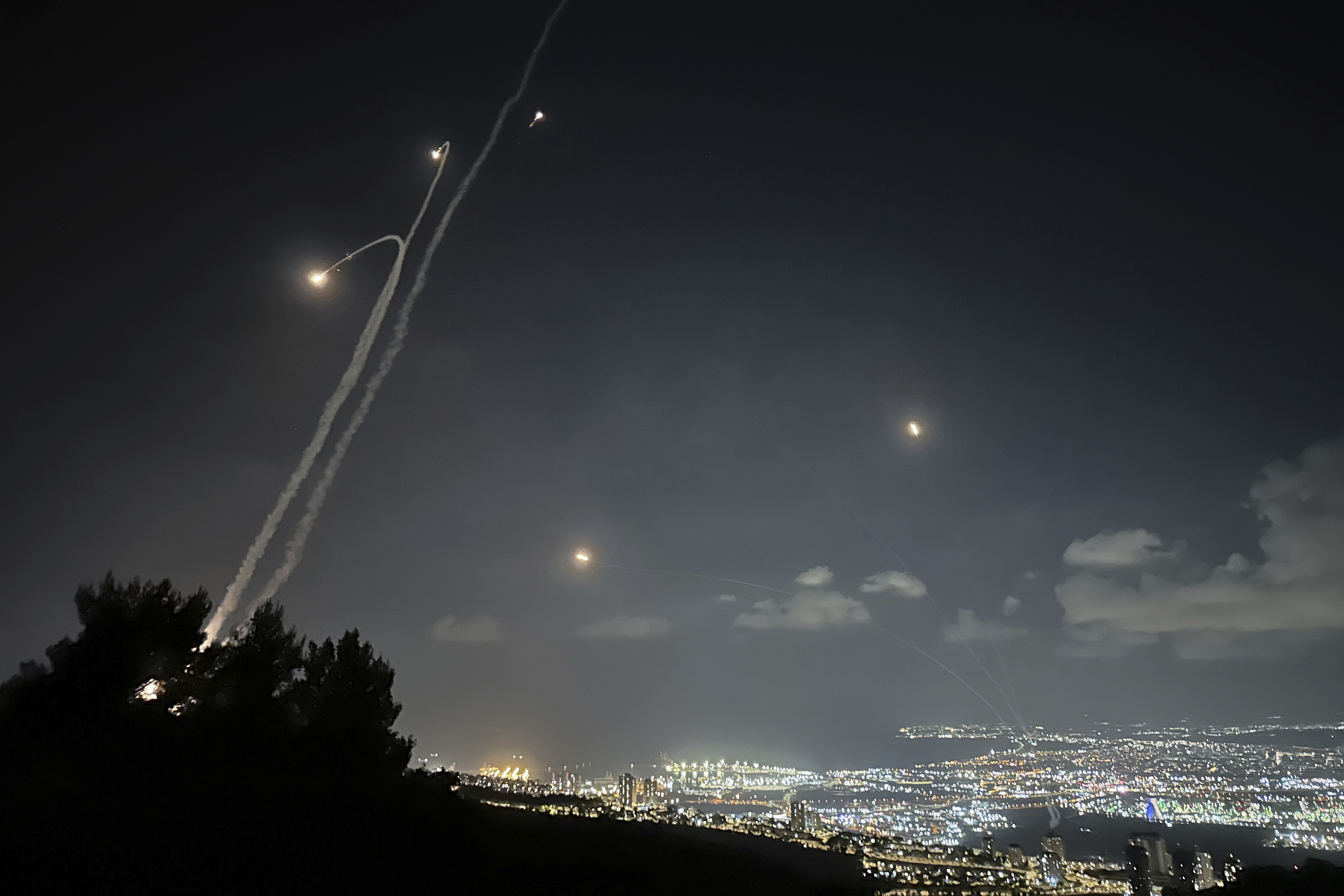 Photo: Israeli Iron Dome air defense system fires to intercept rockets that were launched from Lebanon. (Baz Ratner/AP) 