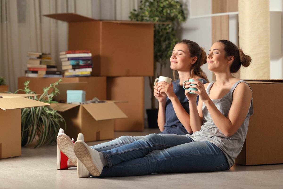 Two women drink coffee at home