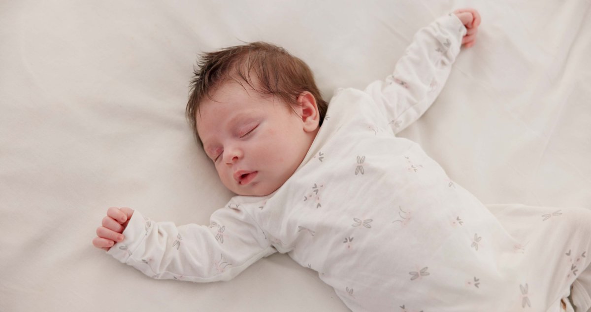 Baby lying on bed