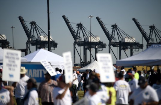 Photo: Dockworkers strike. (MARK FELIX/AFP via Getty Images)