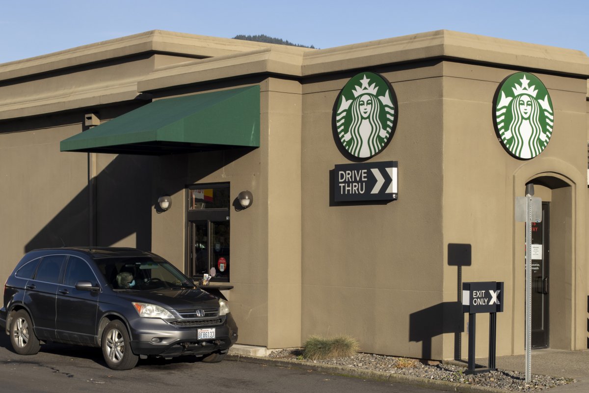 Customer Waits To Collect Order At Starbucks