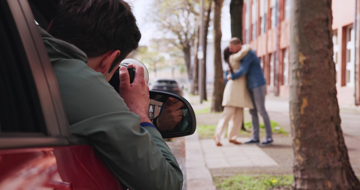 private-investigator-takes-photo How To Catch a Cheating Spouse, According to a Private Investigator