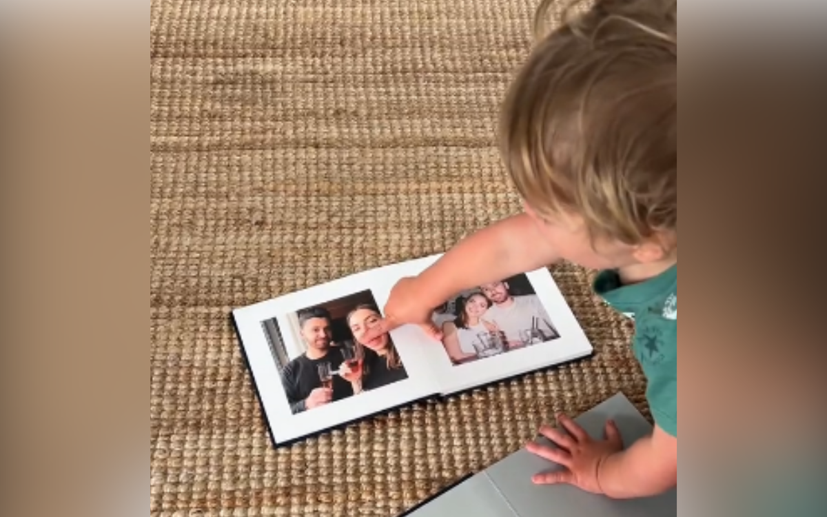 Nathalie's son looks at photos.