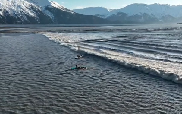 Internet in awe as surfers ride “insane” rare wave in Alaska