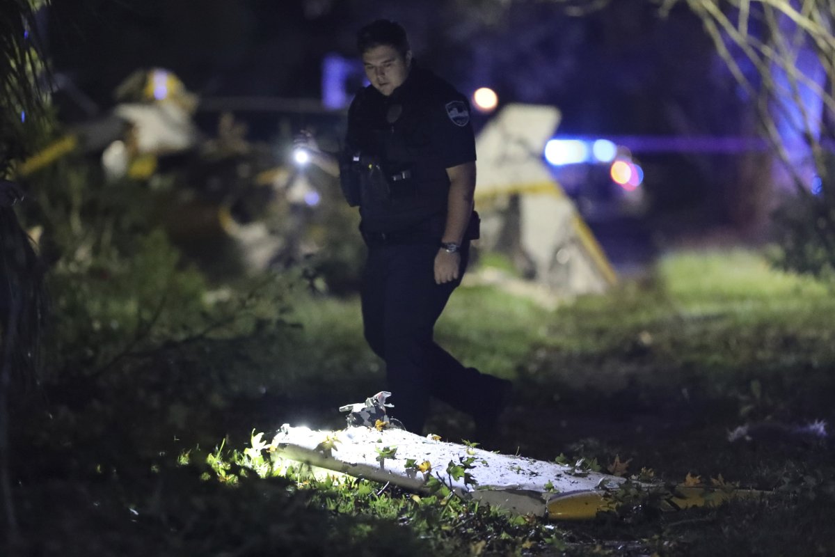 Police examine debris from a plane crash