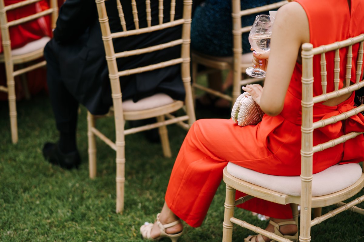 Woman in red suit at wedding