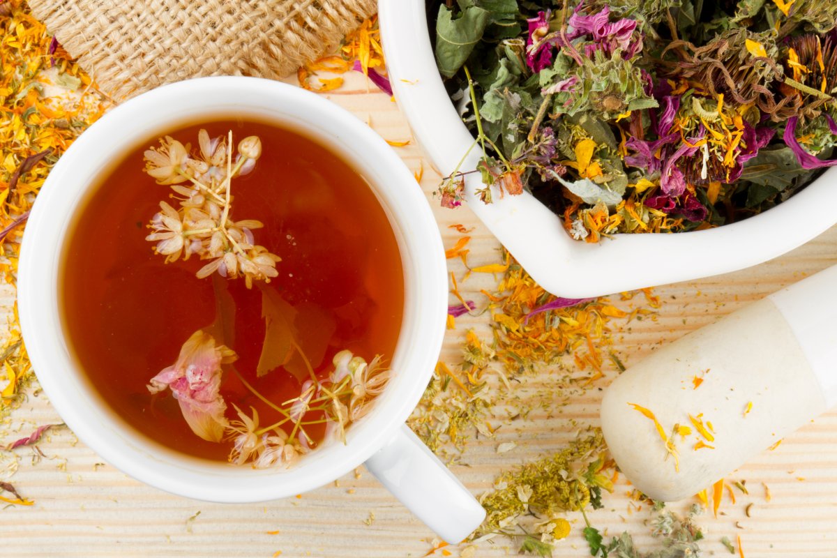 Cup of tea, herbs, mortar and pestle