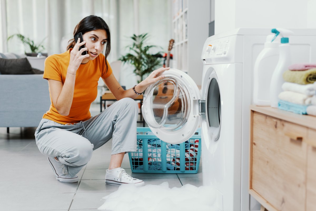 Woman checking washing machine