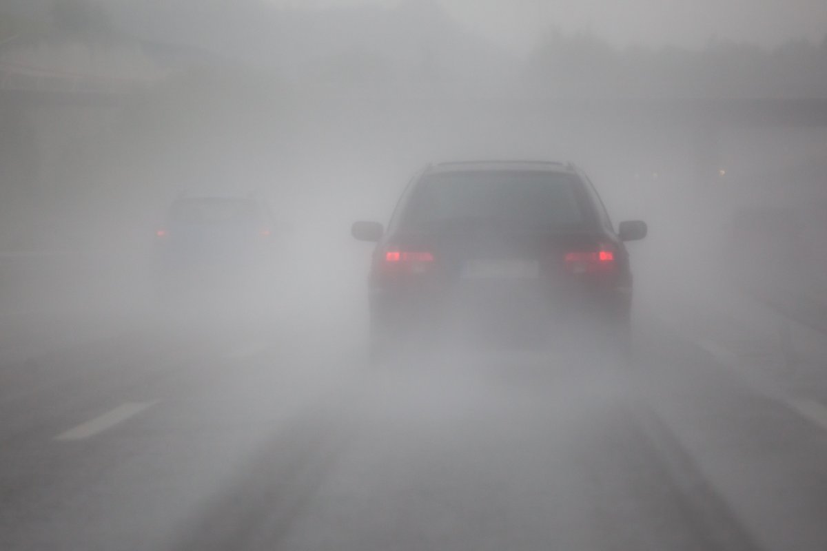 Car driving on a foggy road