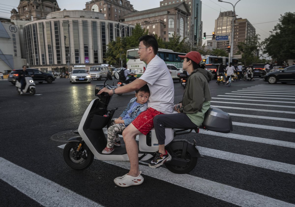 Chinese Family Rides Scooter in Beijing 