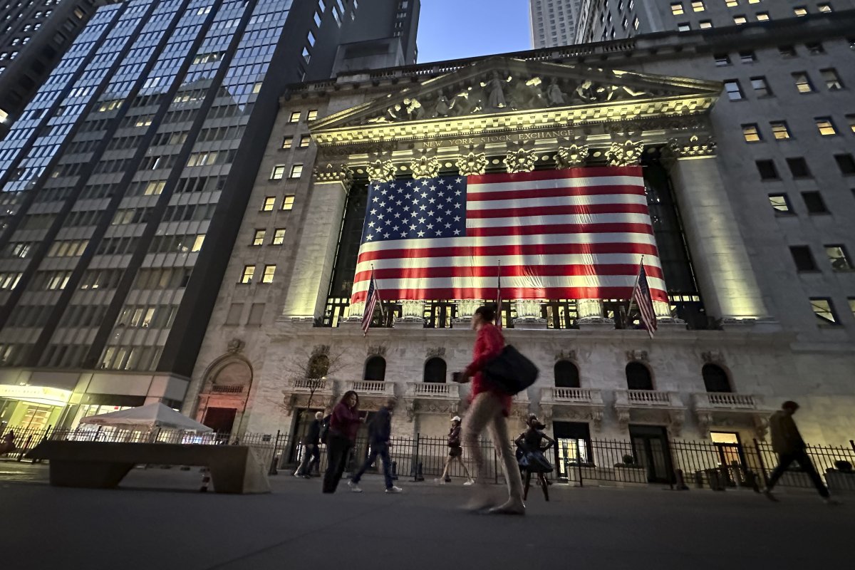 People pass the New York Stock Exchange