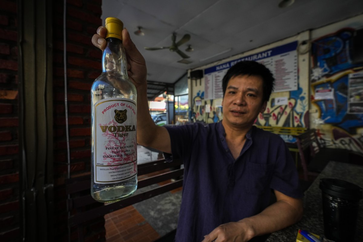 Duong Duc Toan is holding the vodka bottle