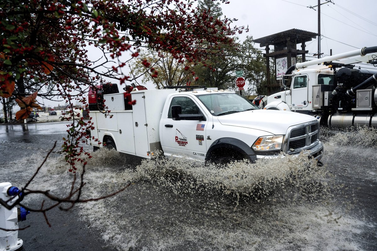 A truck crosses a flooded road 