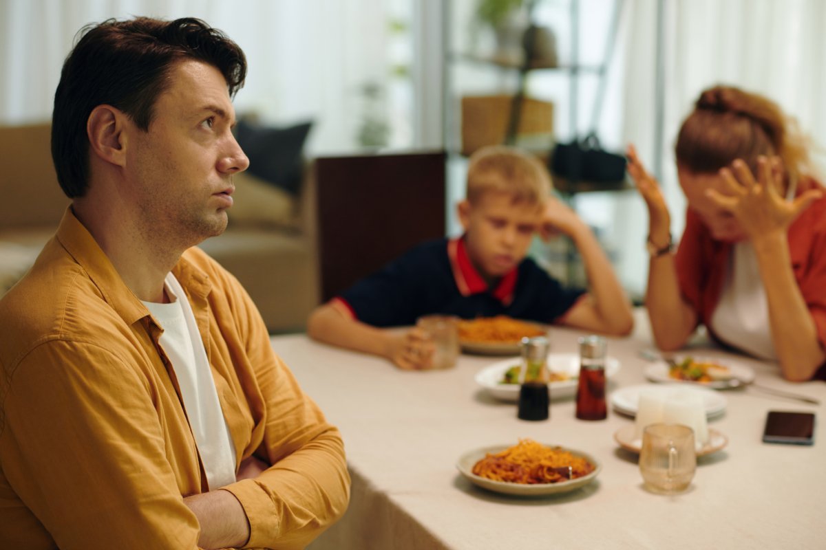 Stock image of family conflict at dinner.