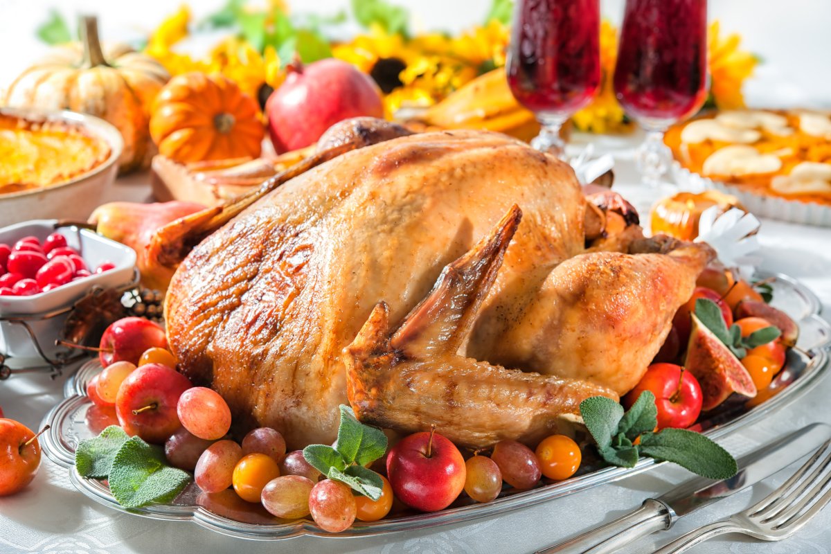 Roasted turkey on Thanksgiving table spread.