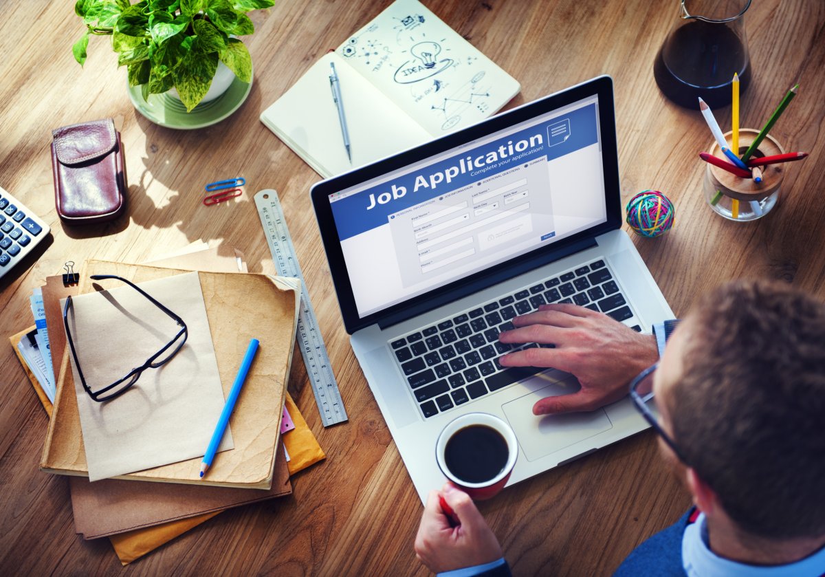 Man applying for job online on laptop.