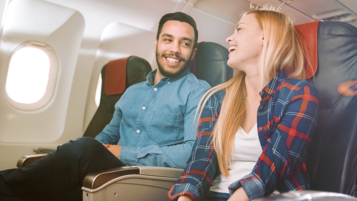 Smiling couple on plane.