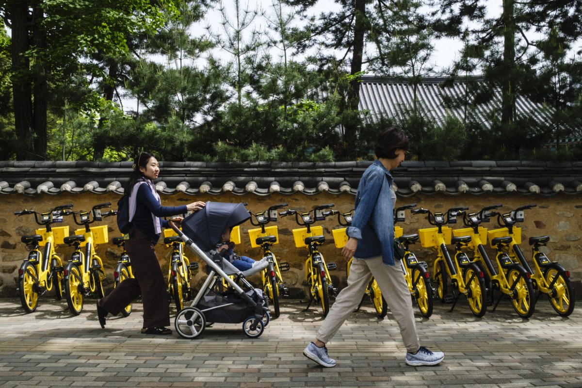 Woman Pushes Stroller in Seoul
