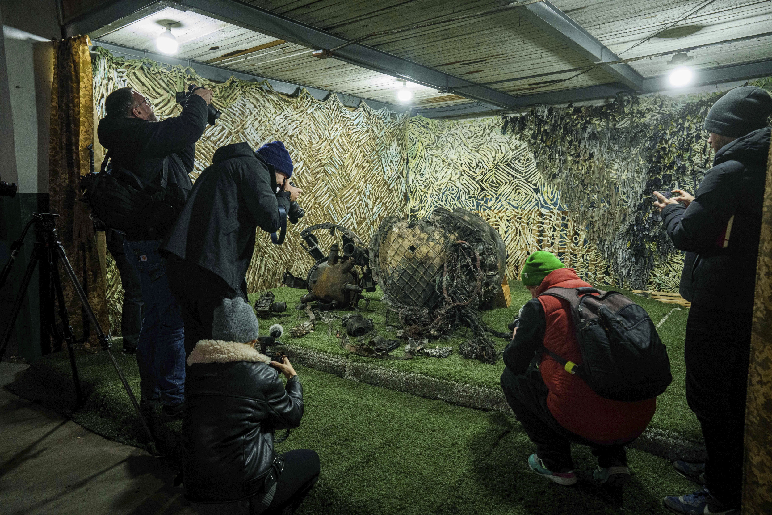 Journalists at a center for forensic analysis film fragments of what authorities in Kyiv described as a Russian hypersonic missile. (AP Photo)