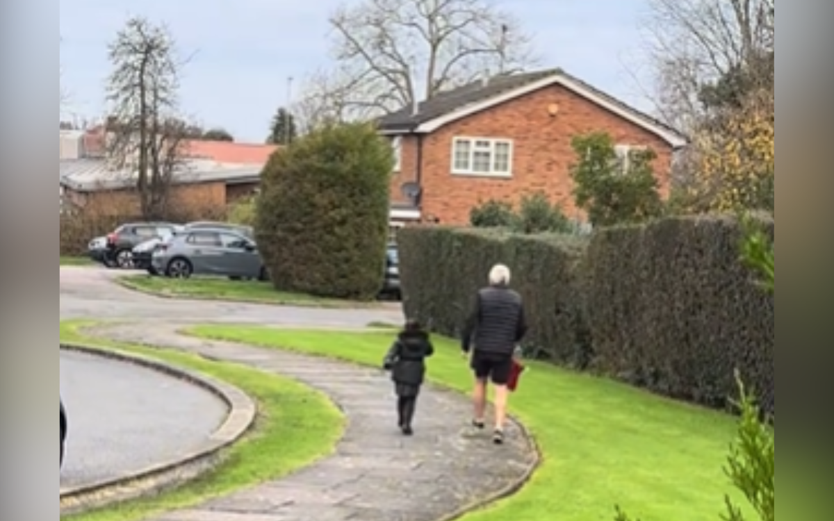 A granddad taking his granddaughter to school.