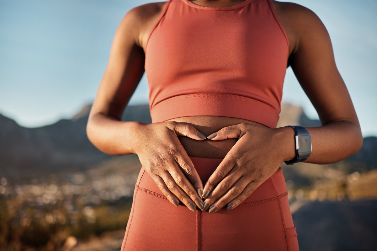 A woman with hands on her belly