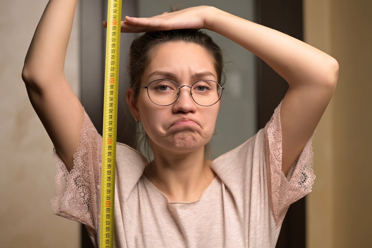 Stock image of woman and tape measure.