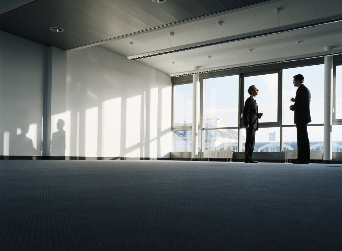 Two men talking in empty office