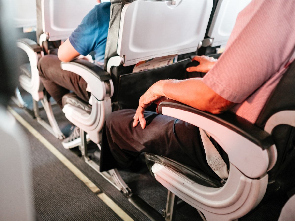 Passengers seated on a plane.