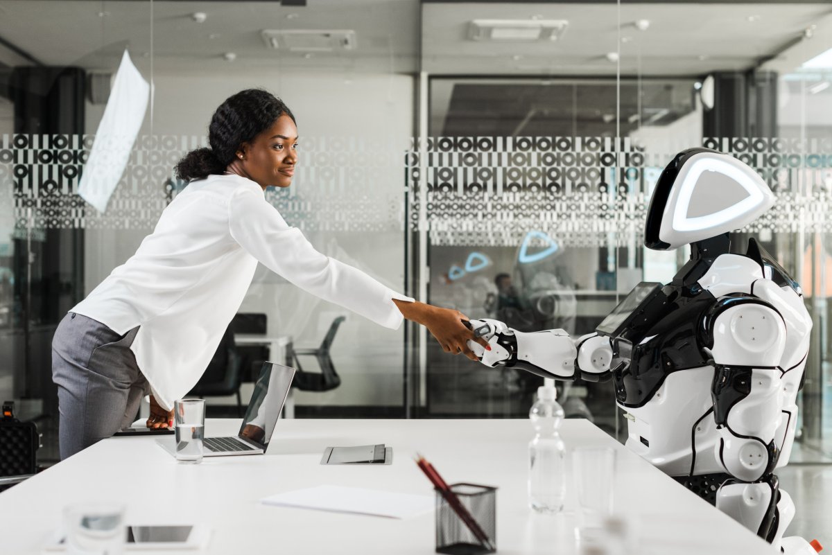 Woman shaking hands with a robot.