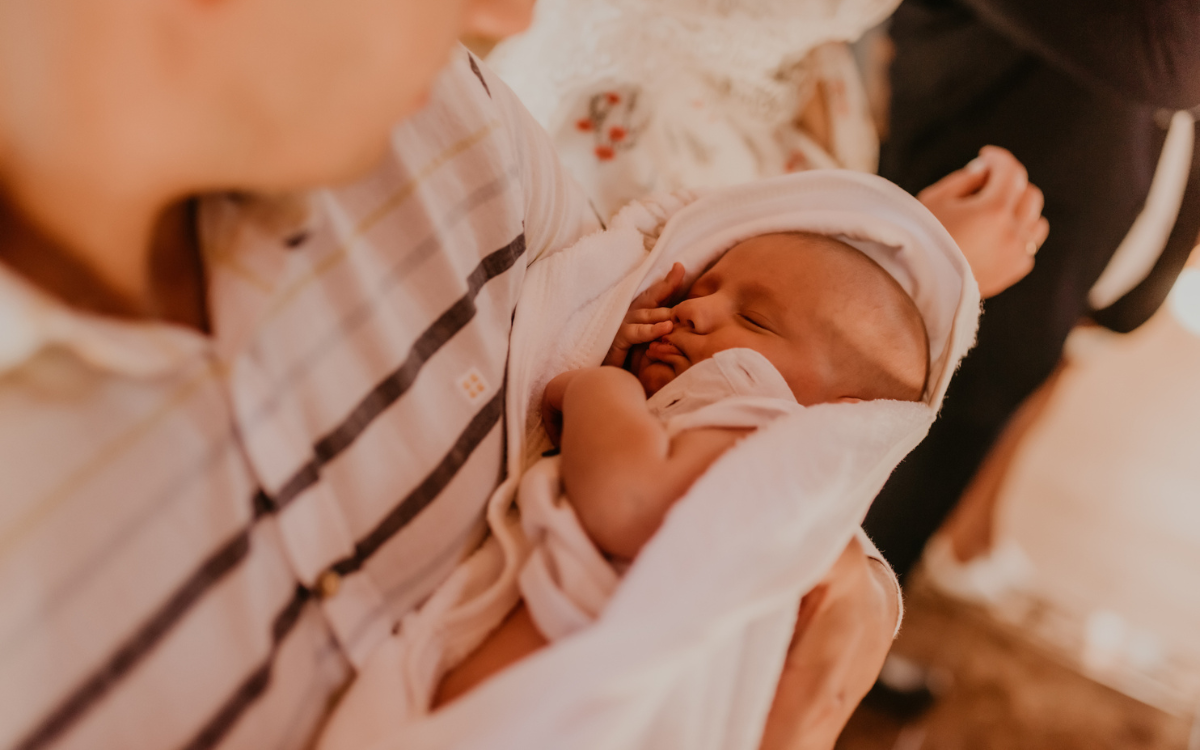 A baby at a christening.