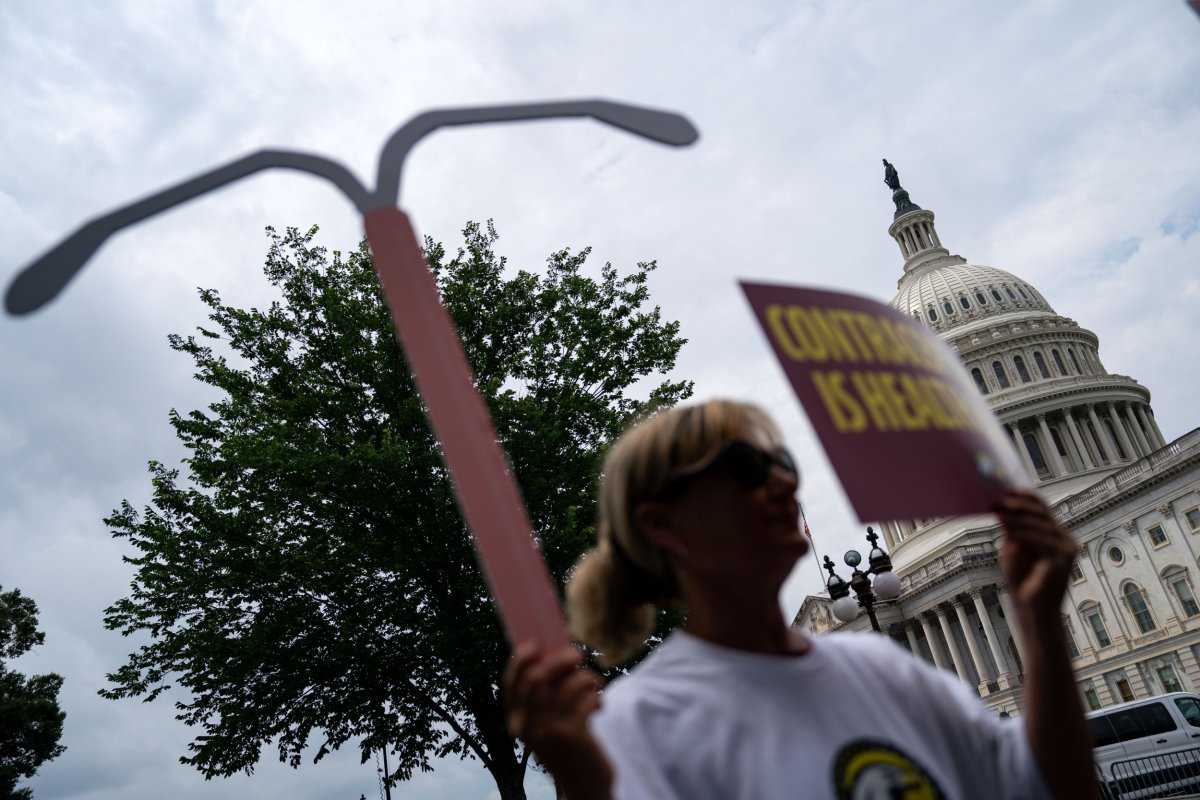 Woman holds up a sign 