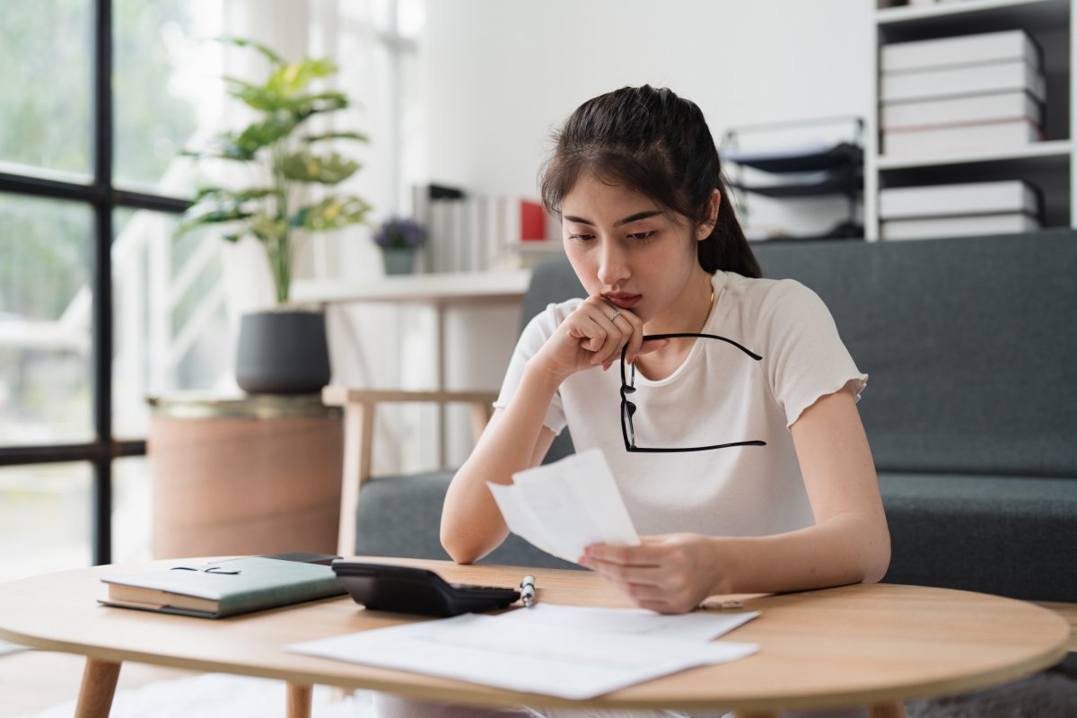 Young Woman Looks at Bills