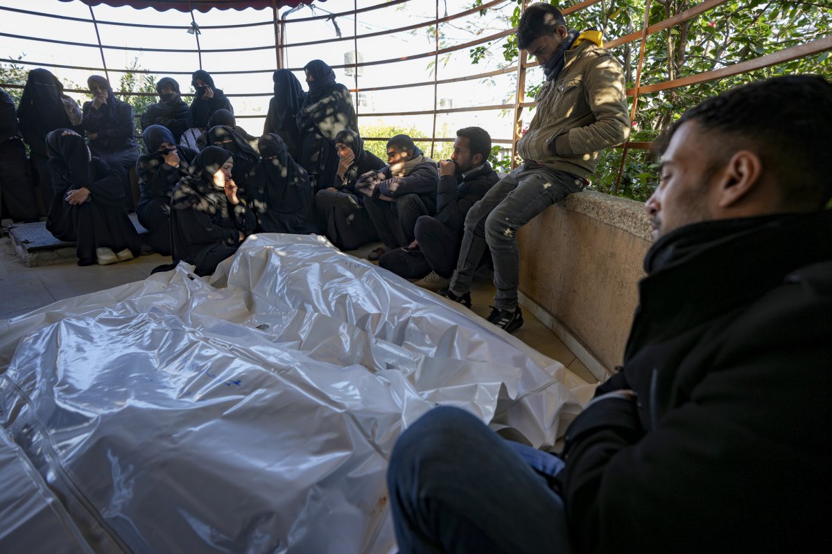 Palestinians next to the bodies of relatives