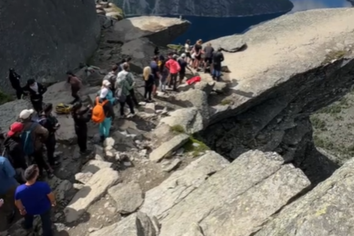 hikers in Norway wait for photo op