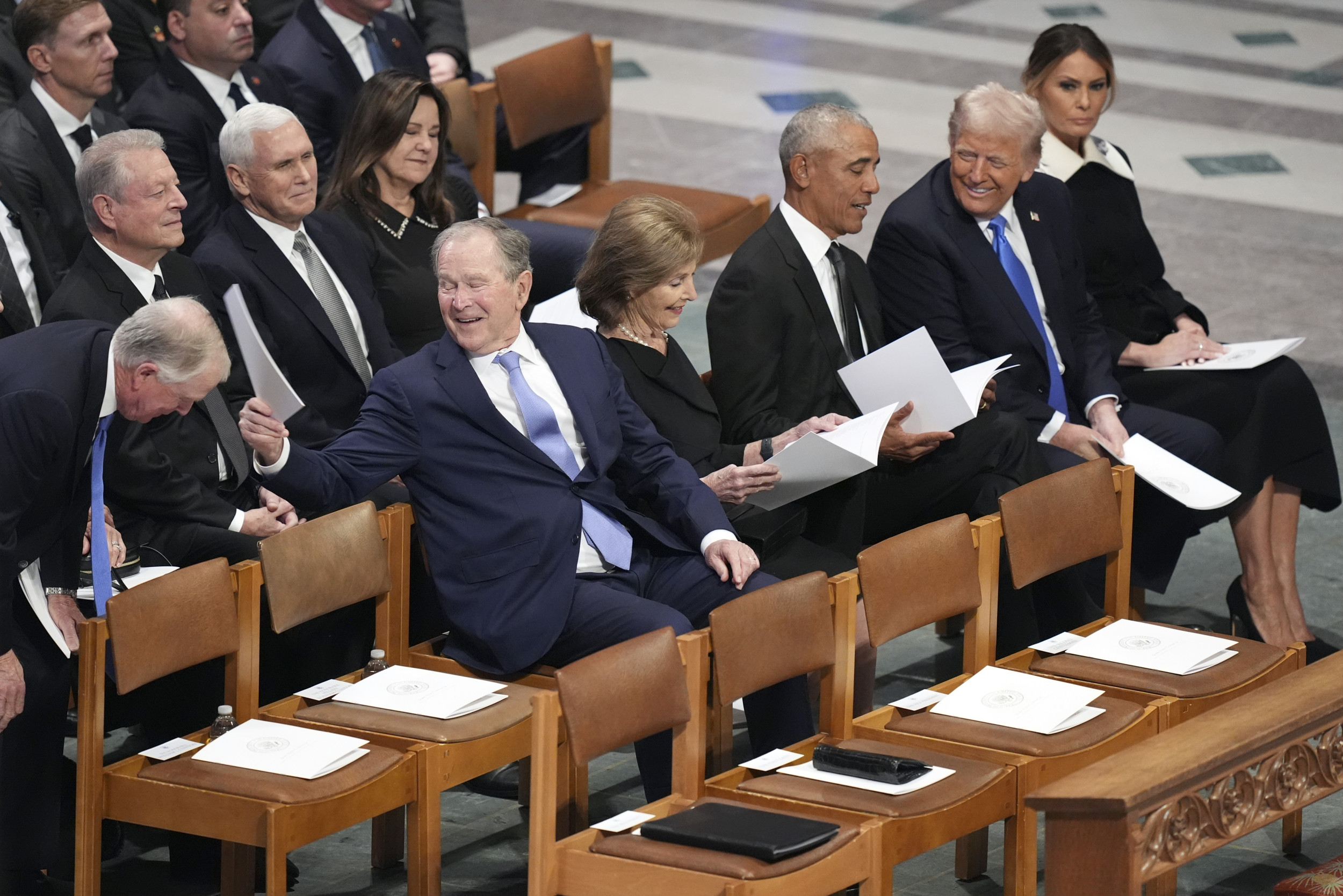 Video of Trump making Obama laugh at Carter funeral takes off online