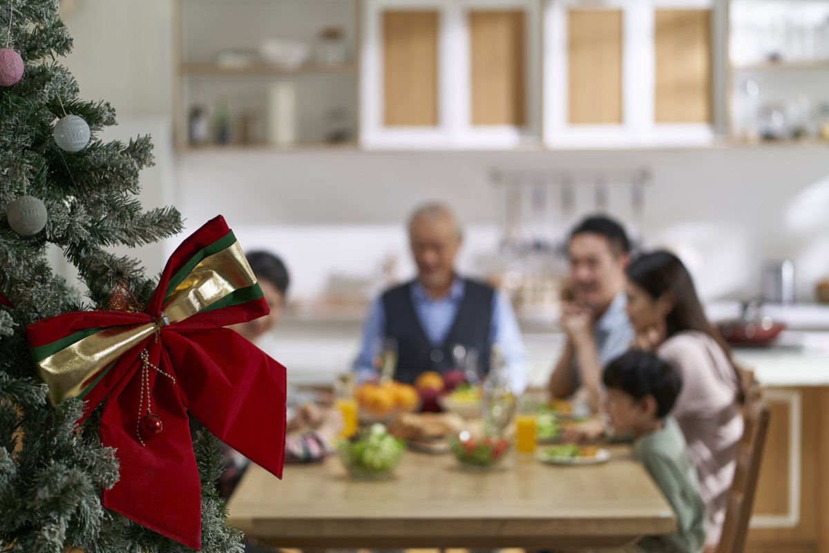 Family Sit Down For Christmas Dinner