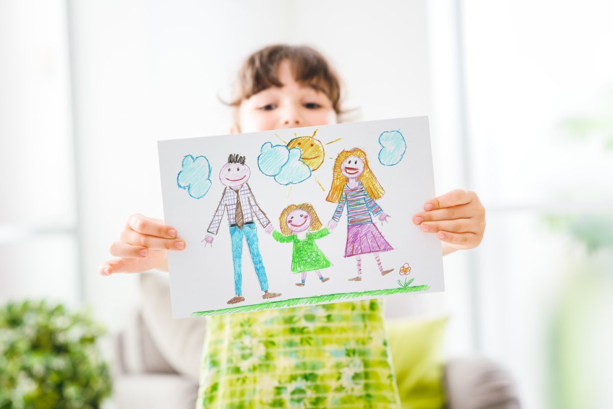 A child shows off her drawing 