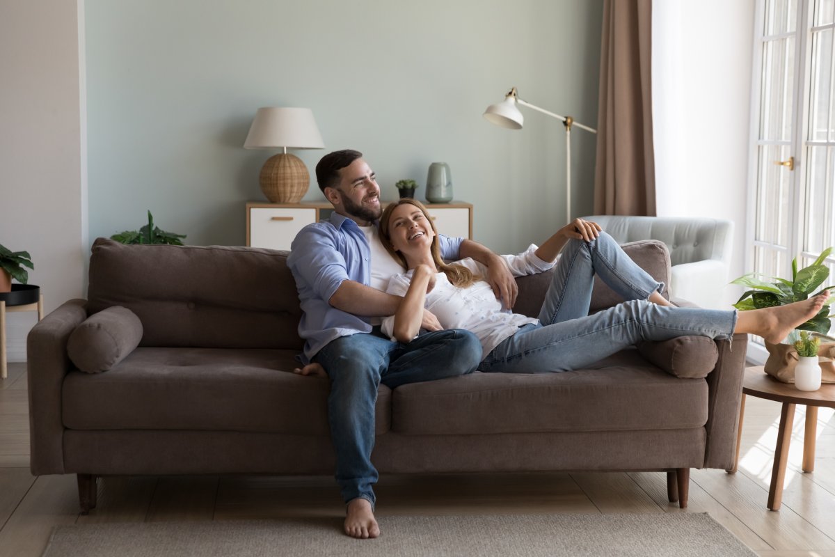 A couple lie on their sofa 