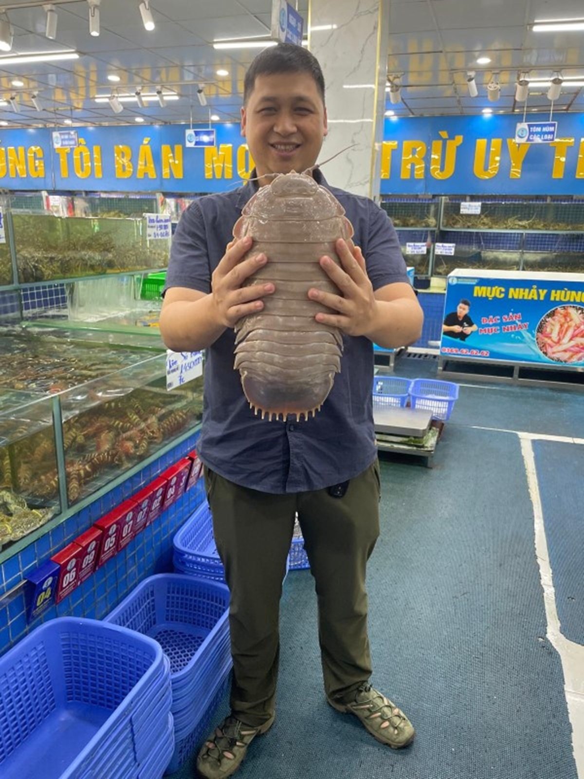 Researcher Nguyen Thanh Son holds an isopod