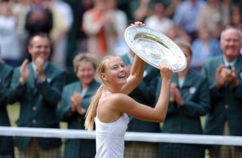 Maria Sharapova holding the Wimbledon trophy after beating Serena Williams in 2004, aged 17