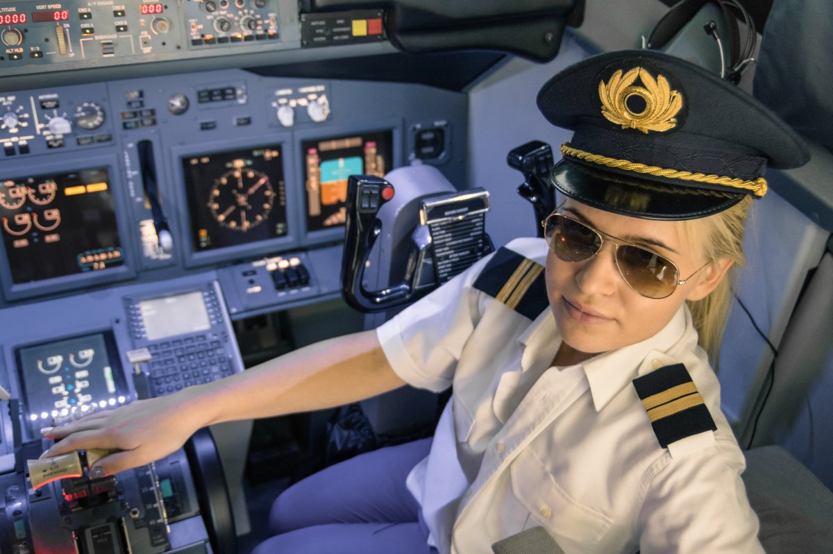 Female pilot sitting in plane cockpit.