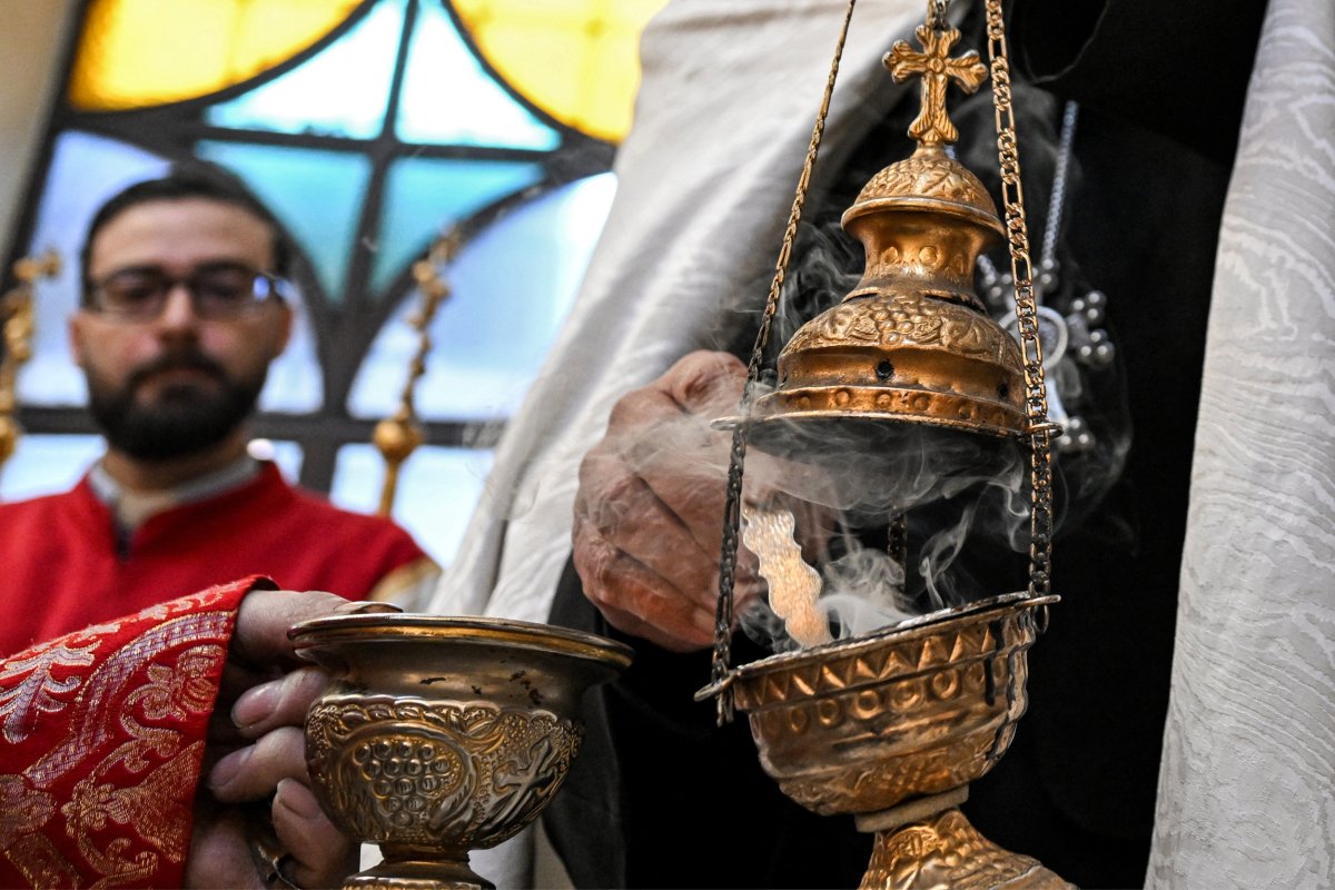 A priest lights a censer