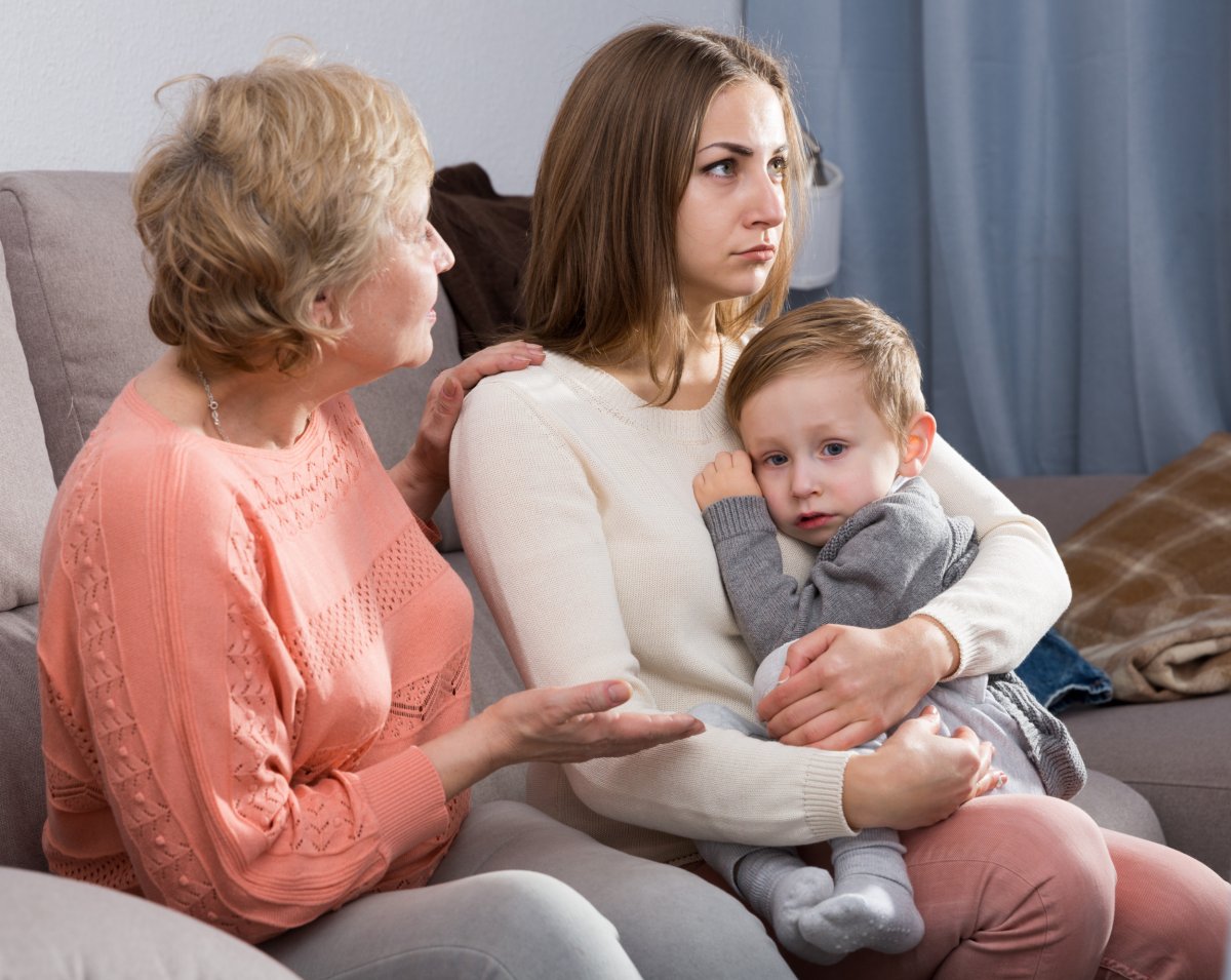 MIL and frustrated woman holding child 