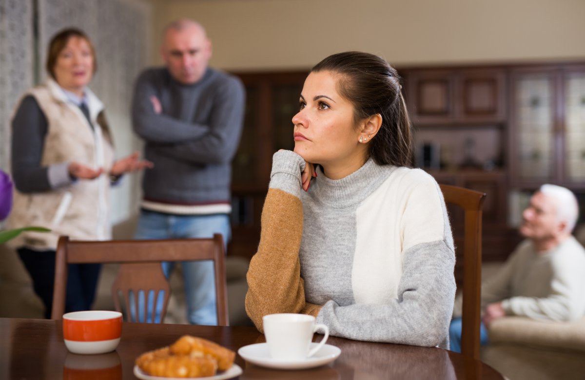 A woman turns away from her family
