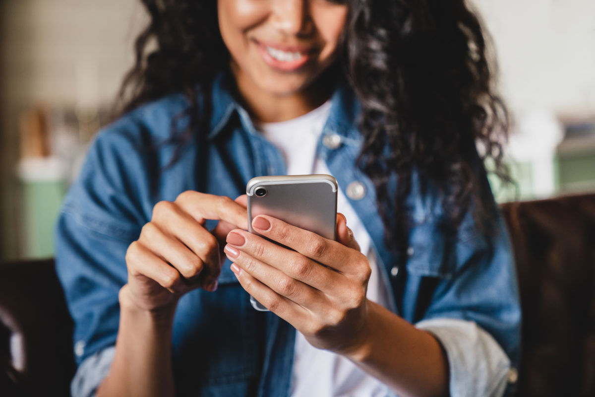 Woman Blue Jean Jacket Smiles Cell Phone