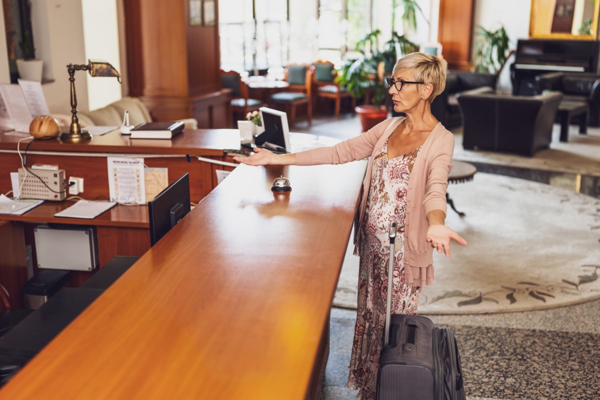 Stock image - Guest at front desk