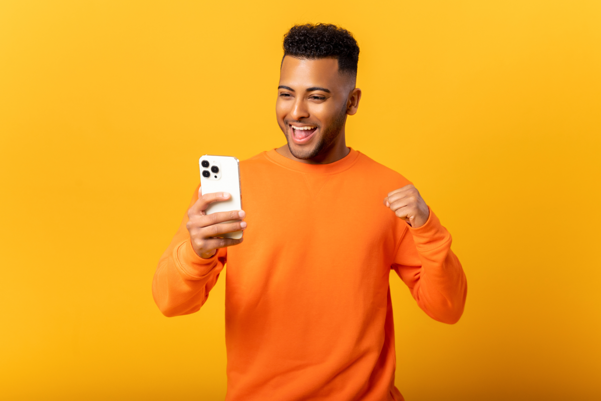Man Orange Shirt Yellow Background Cell Phone